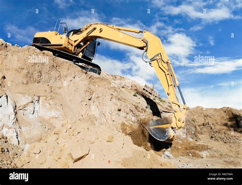 excavator digging hillside foundation Stock Photo - Alamy