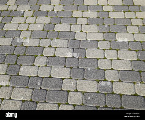 Industrial Building Background Of Paving Slabs With Overgrown Wi Stock