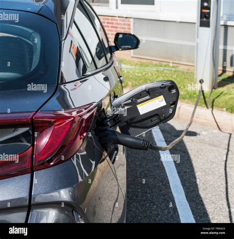 A hybrid car which is also an electric plug in at a free charging station for even better ...