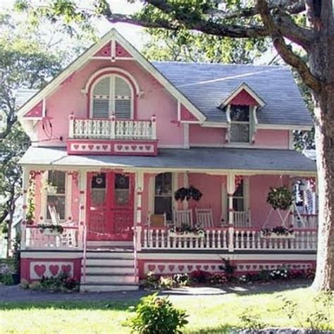 Pink Cottage With White Trim And Porches