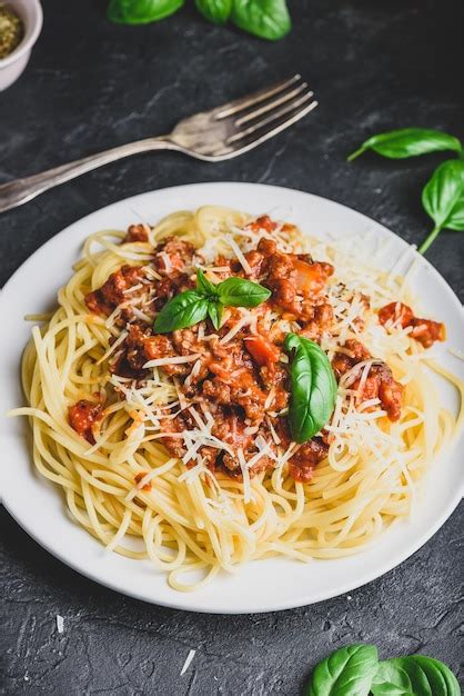 Premium Photo | Spaghetti with bolognese sauce parmesan and basil