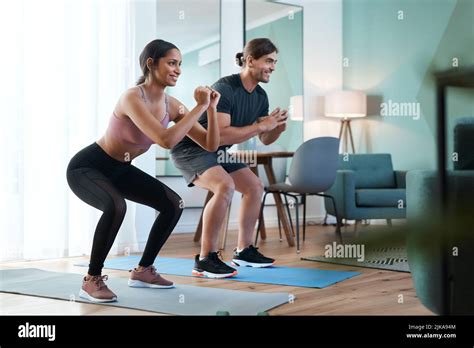 Squat Squad Full Length Shot Of An Athletic Young Couple Squatting On