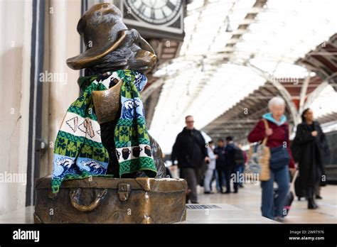 The Paddington Bear Statue At Paddington Station London Wears A