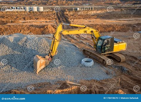 Excavator At Earthworks On Construction Site Backhoe Loader Digs A Pit