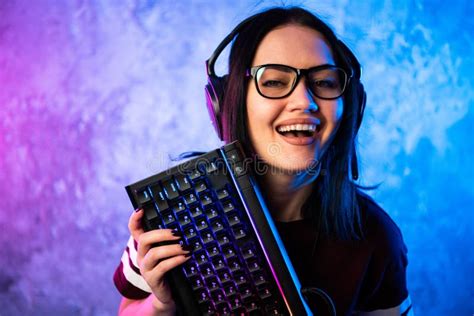 Beautiful Friendly Pro Gamer Streamer Girl Posing With A Keyboard In Her Hands Wearing Glasses