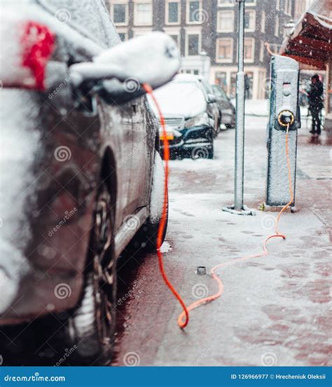 Electric Car Plug Charging In The Winter Stock Image Image Of