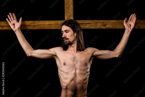 Shirtless Man Crucified On Wooden Cross Isolated On Black Stock Photo