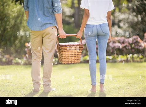 Midsection Of A Couple Holding Picnic Basket Stock Photo Alamy