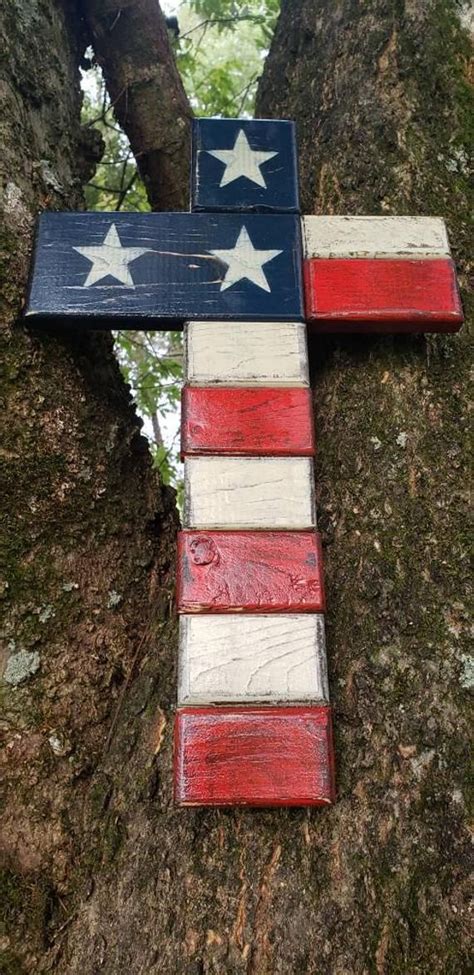 A Cross Made Out Of Wooden Planks In The Shape Of An American Flag On A