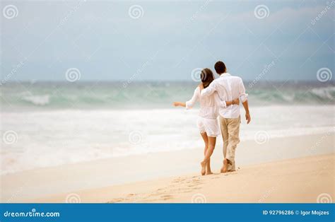 Embracing Couple Walking Along Beach Stock Photo Image Of Ocean