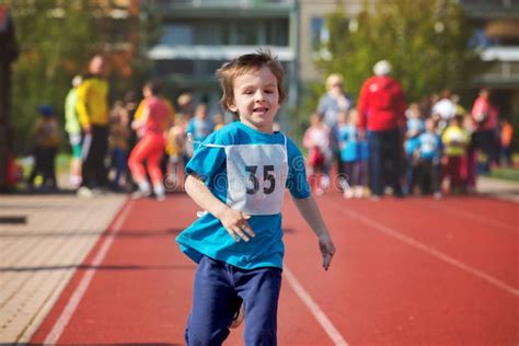 Young Preschool Children Running On Track In A Marathon Competition