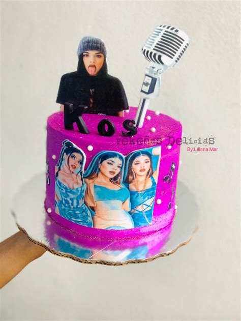 A Pink Cake Decorated With Photos And A Microphone