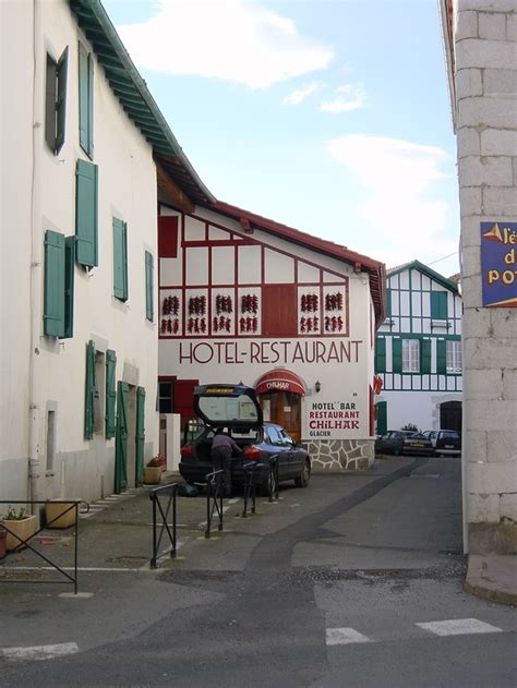 An Old Building With Cars Parked In Front Of It