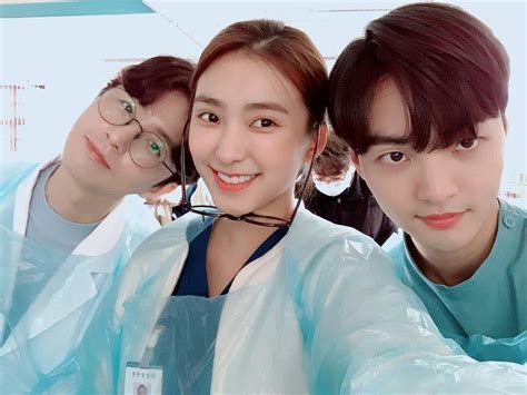 Three People In Scrubs Are Taking A Selfie