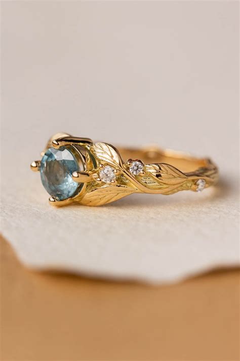 Blue Sky Sapphire Engagement Ring Gold Leaves And Accent Diamonds