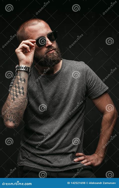 Portrait Of A Handsome Balded Man With Long Well Trimmed Beard Wearing