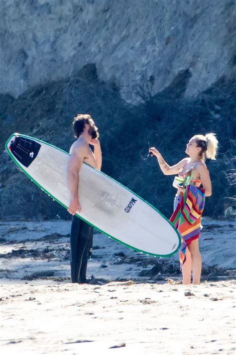 Miley Cyrus And Liam Hemsworth Hold Hands On The Beach After His