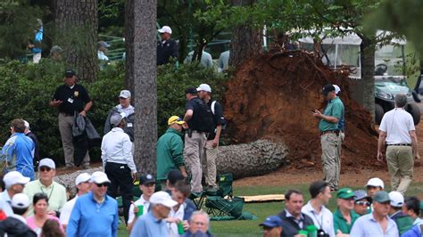 Watch terrifying moment 100ft trees fall into fans at Augusta as huge storms force Masters to be ...