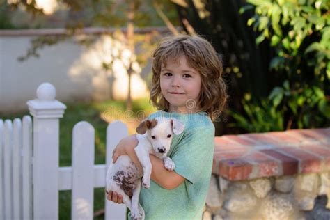 Kid with Puppies Kissing and Hugging. Lovely Child with Dog Walking ...