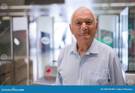 Portrait Of European Old Man Standing At Entrance To Subway Station