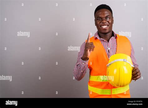 Young African Man Construction Worker Against White Background Stock