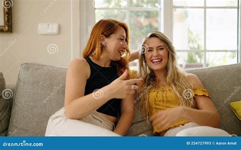 Two Women Sitting On Sofa Speaking At Home Stock Image Image Of Rest