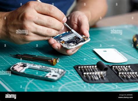 electronics repair service technician disassembling smartphone