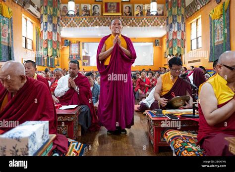 A Nepalese Monk In Traditional Robes Recites Prayers Meditates With