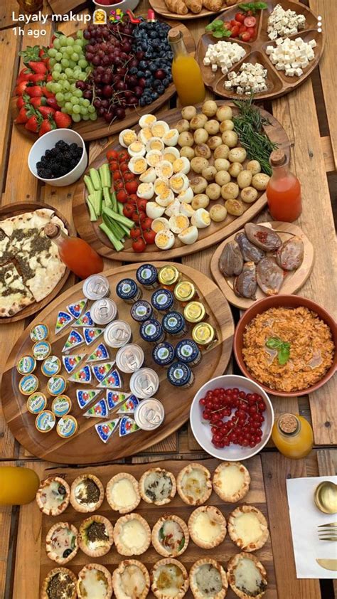 A Wooden Table Topped With Lots Of Different Types Of Foods And