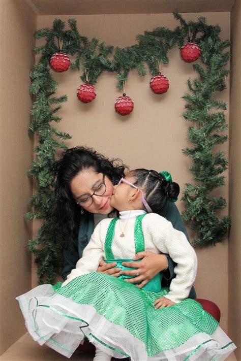 Mom With Her 5 Year Old Brunette Daughter With Eyeglasses Inside A Decorated Gift Box To