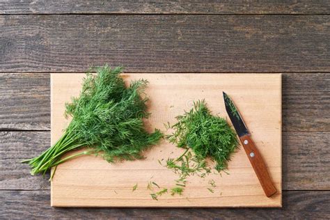 Fresh Chopped Green Dill Leaves On A Cutting Board Top View Stock