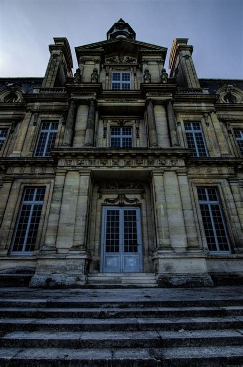 An Old Building With Steps Leading Up To The Front Door And Sky In The