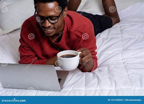 Young Man Using His Laptop in Bed Stock Image - Image of modern ...