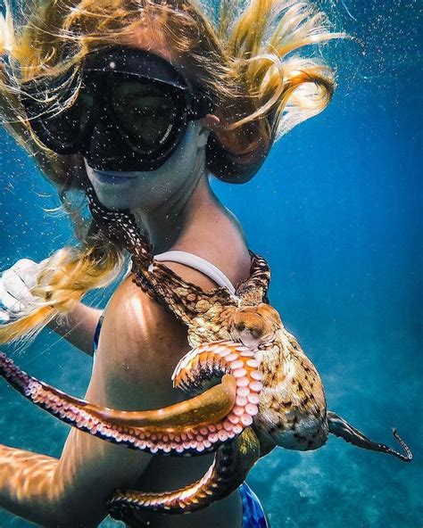 A Woman With An Octopus On Her Back In The Water Wearing Goggles And