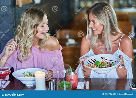 Two Girl Friends Eating Lunch In Restaurant Stock Photo Image Of