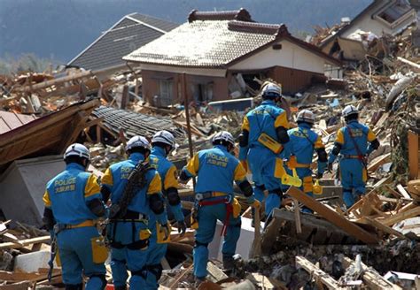 Tsunami And Earthquake In Japan Rescue Workers Search For Survivors