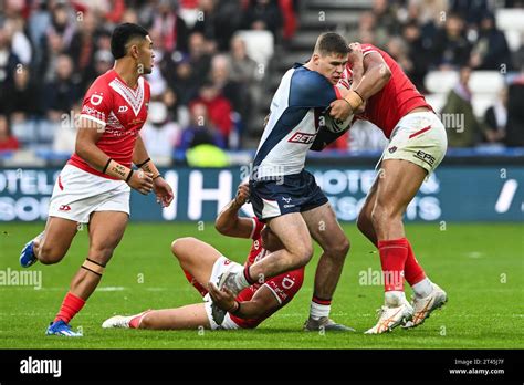 Jack Welsby Of England Is Tackled By Haumole Olakau Atu Of Tonga And