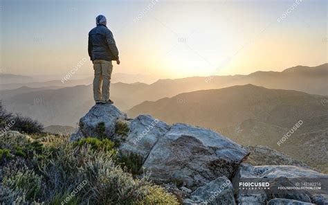 Standing At Top Of Mountain