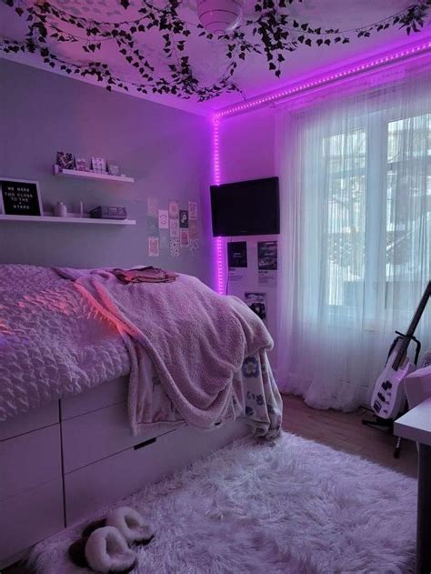 A Bedroom With Purple Lighting And White Fur Rugs On The Floor Along With A Bed In Front Of A