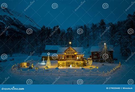 Traditional Bright Lit Log Cabin Situated Atop a Snow Covered Mountain Captured at Night Stock ...