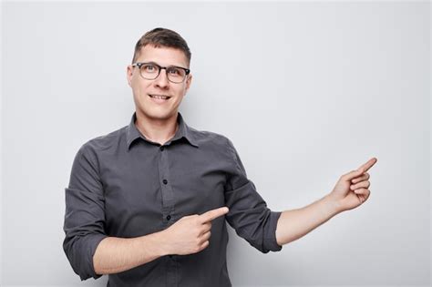 Premium Photo Handsome Man In Glasses Pointing Aside Finger