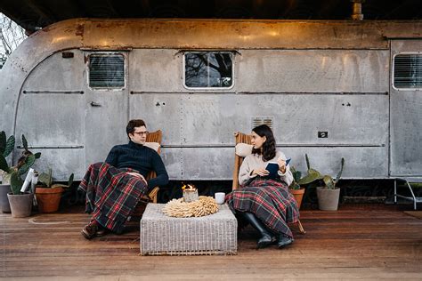 Adult Couple Chilling At The Porch Of A Travel Trailer By Stocksy