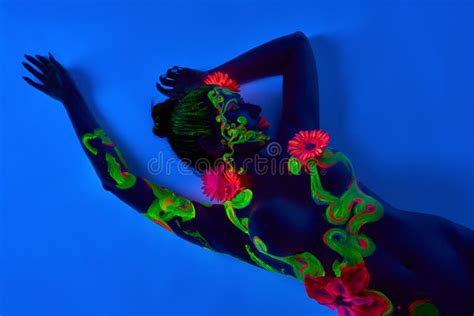 Naked Woman With Painted Body And Flowers In Darkness Stock