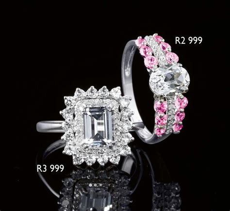 An Engagement Ring With Pink And White Stones On The Side In Front Of