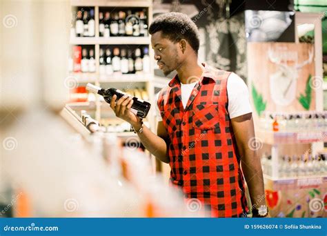 African Man Shopping In Wine Section At Supermarket Black Man Doing