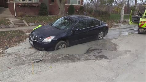 Car In Albany Park Partially Swallowed By Sinkhole YouTube