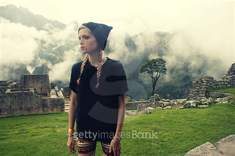 Caucasian Blond Woman In Misty Clouds Over Machu Picchu Peru