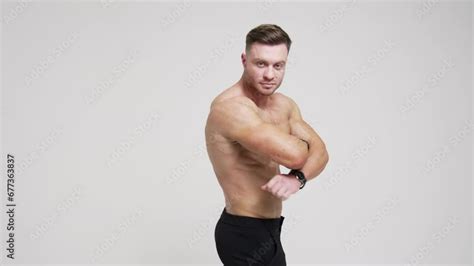 Caucasian Man Standing His Back To Camera Turns Around To Camera Athlete With Naked Torso