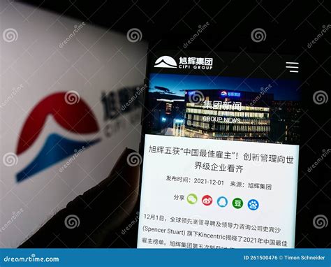 Person Holding Mobile Phone With Webpage Of Chinese Real Estate Company