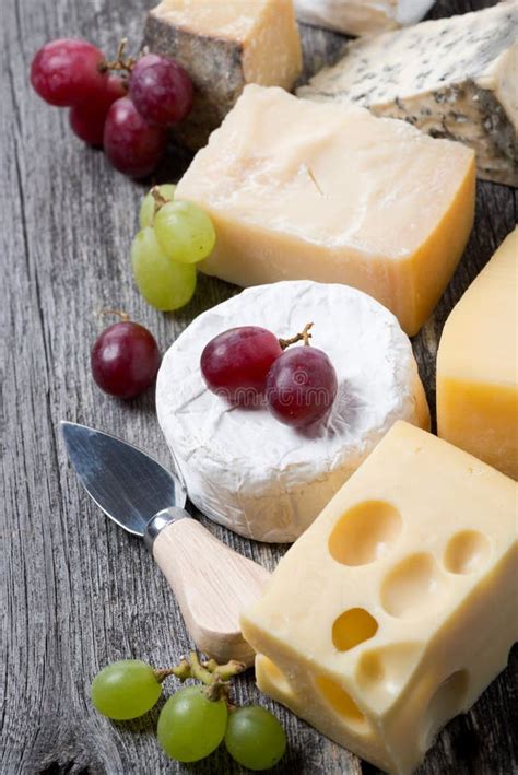 Assortment Of Cheeses Glass Of Red Wine Grapes And Crackers Stock